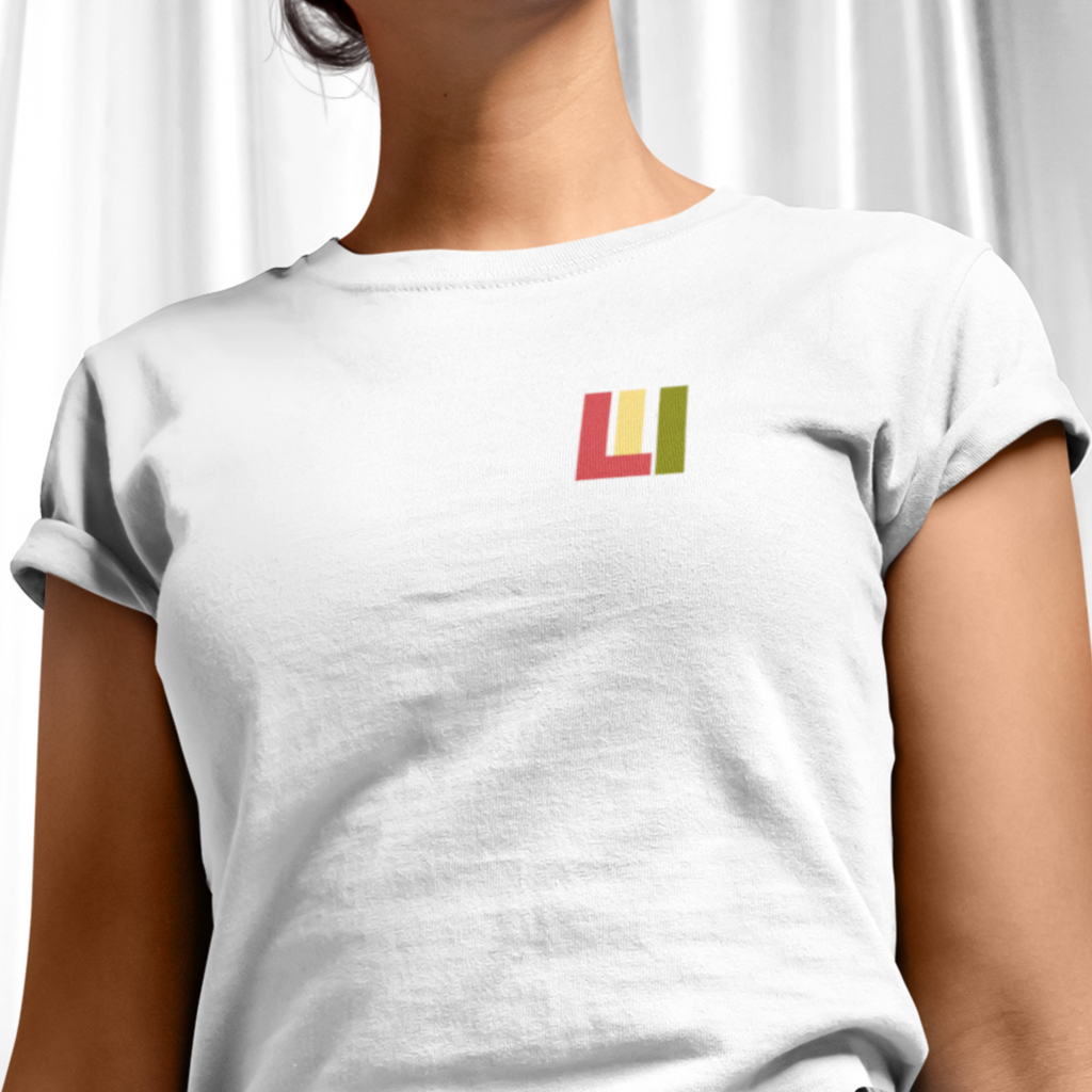 White knit t-shirt featuring front icon graphic in Reggae colors of red, gold, green. On the back "life is irie" logo graphic. 