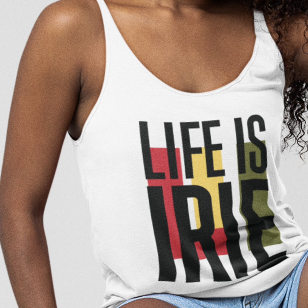 White racerback knit tank featuring "life is irie" text graphic with Reggae colors of red, gold, green.