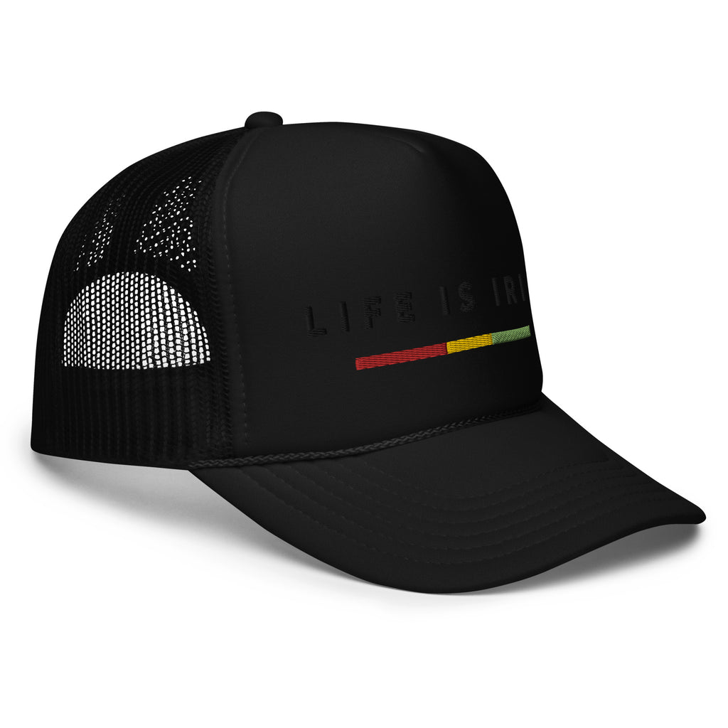 Black trucker hat featuring front 3D embroidered "life is irie" text and Reggae stripe in red, gold, green. Mesh back with adjustable closure.  