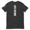 Dark grey heather knit t-shirt featuring on back "life is irie" text graphic.  On the sleeve Reggae colors of red, gold, green