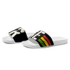 Women's slides featuring Black and white cushioned upper strap featuring "irie" text with Reggae stripes.